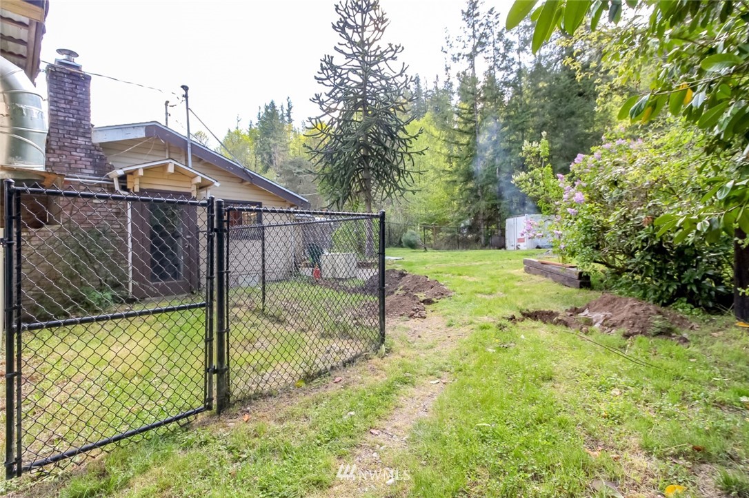 19861 Renton-Maple Valley Road Renton, WA 98058 - Photo 31 of 32 a view of a house with a small yard and wooden fence