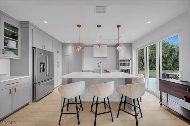 a view of swimming pool with seating area and trees in the background