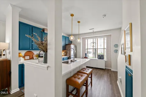 a very nice looking dining room with a large window and wooden floor