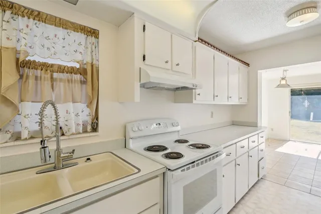 a utility room with cabinets washer and dryer