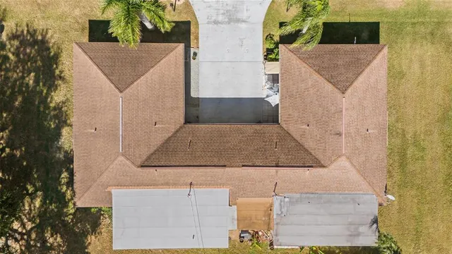 aerial view of a house with a yard