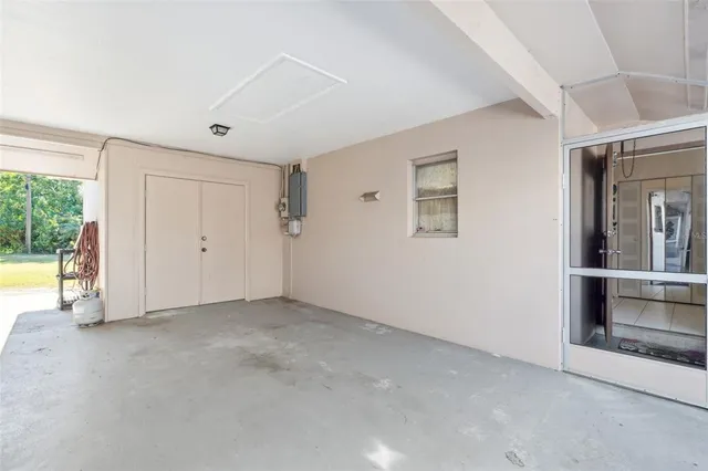 an empty room with windows and entrance