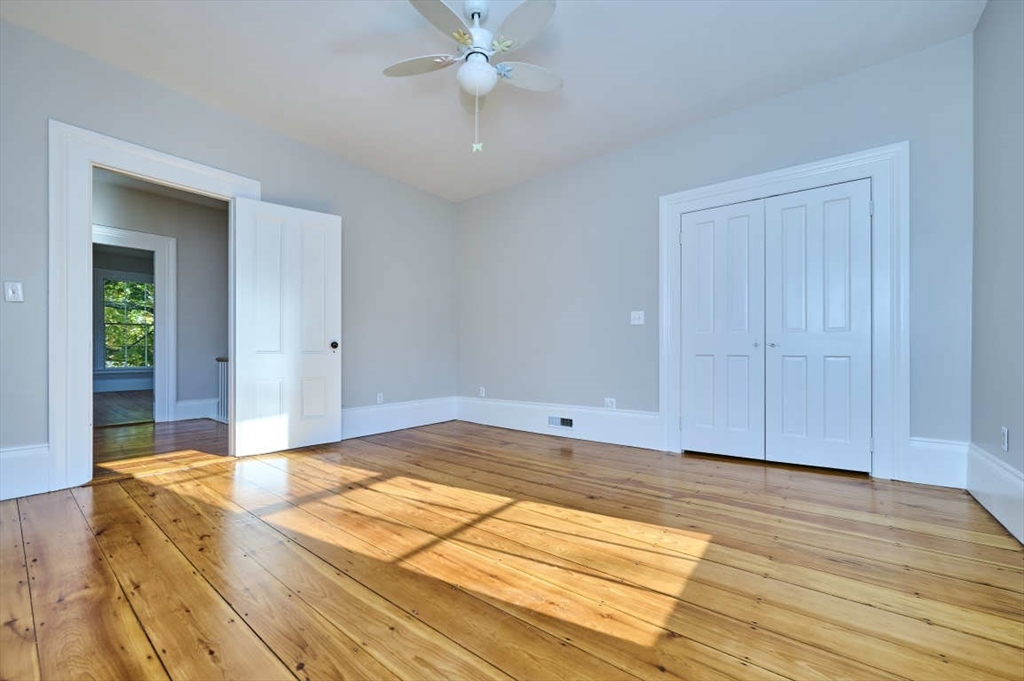 97 River Road Merrimac, MA 01860 - Photo 27 of 42 a bedroom with a bed and a chandelier