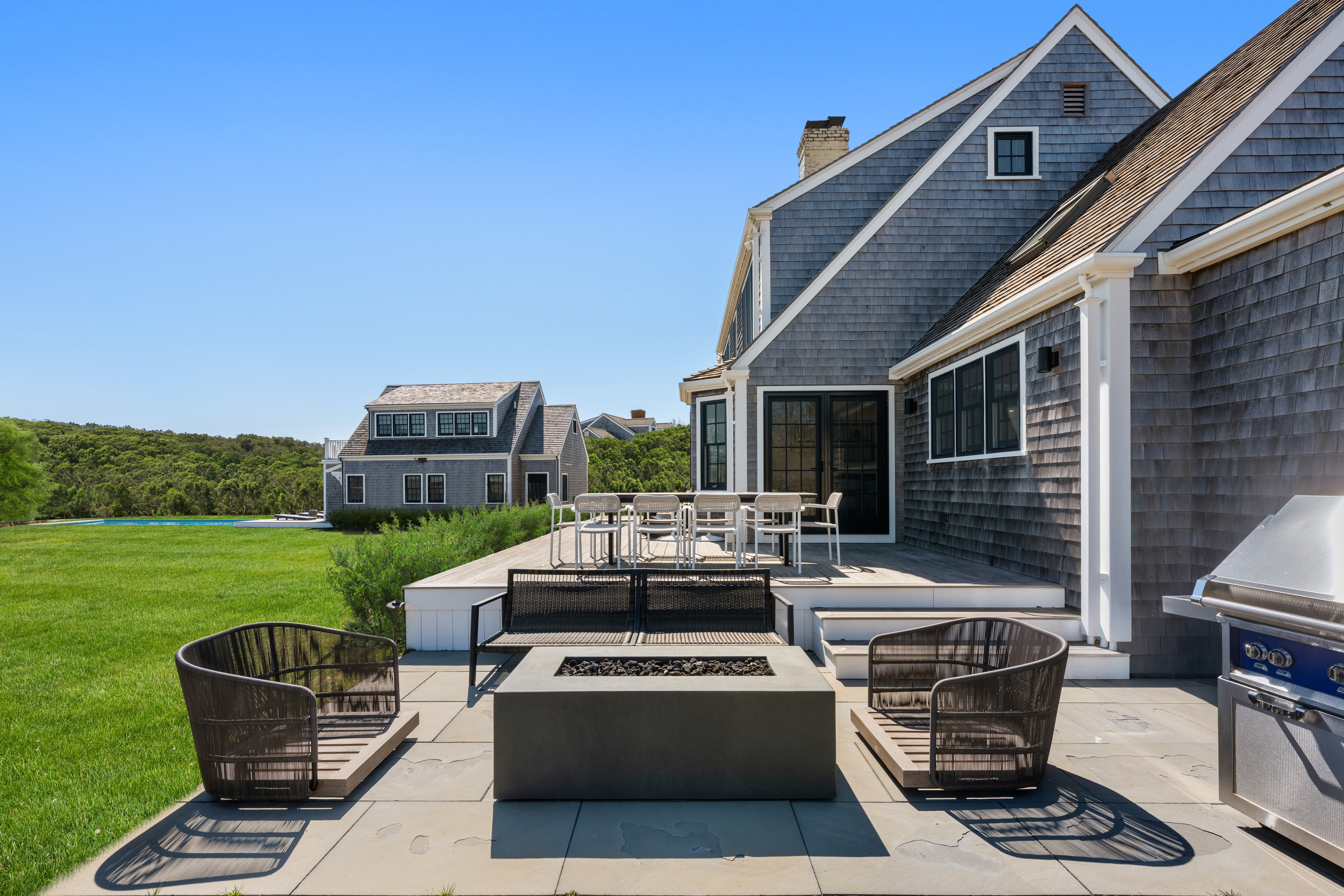 174 Cliff Road Nantucket, MA 02554 - Photo 13 of 49 a view of a patio with couches chairs and a yard