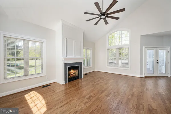 a bedroom with a bed and a ceiling fan