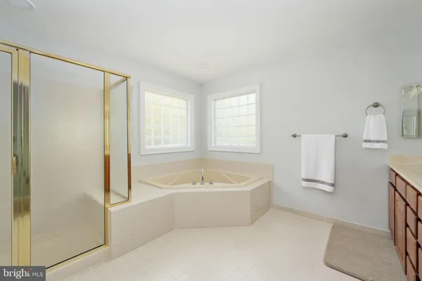 a bedroom with a bed and windows