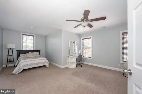 a bedroom with a bed and ceiling fan