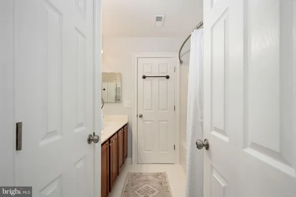 a kitchen with white cabinets appliances and sink
