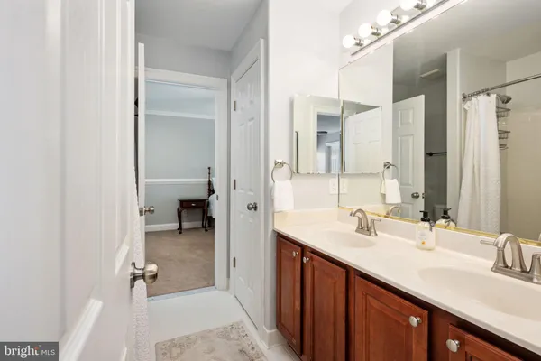 a kitchen with granite countertop a sink cabinets and wooden floor
