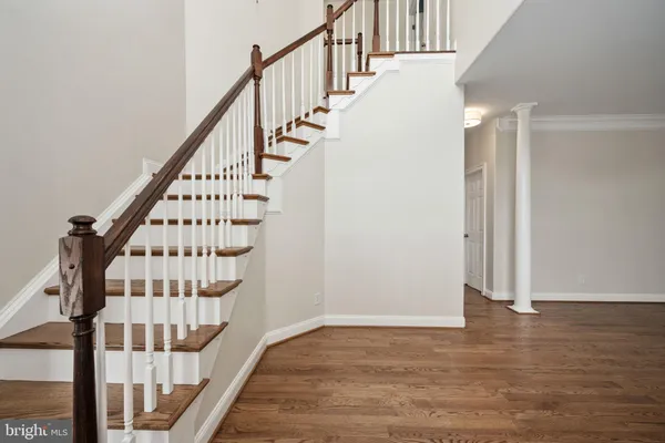 a view of entryway and hall with wooden floor