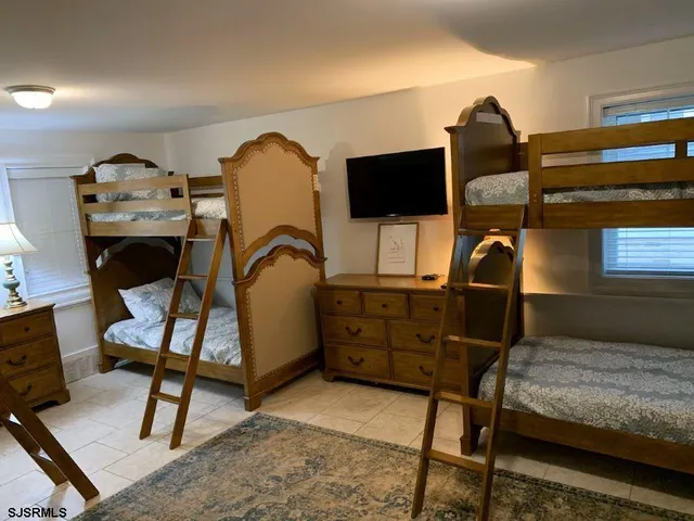 a bedroom with furniture and a window