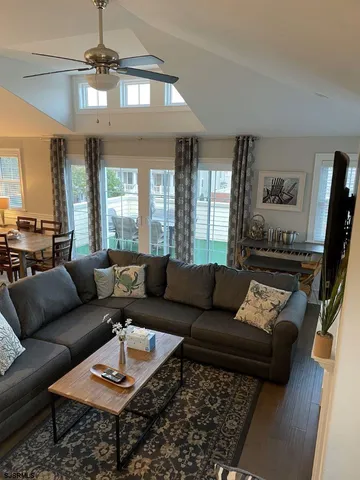 a living room with furniture and a chandelier