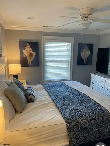 a bedroom with a bed and dresser with mirror