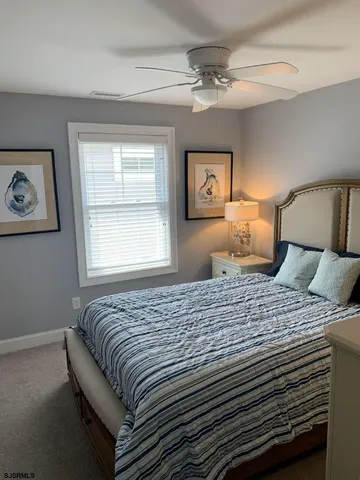 a bedroom with bed and window