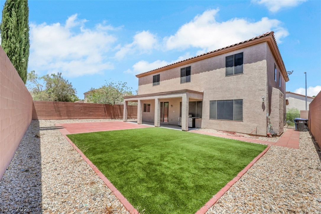 2501 Bechamel Place Henderson, NV 89044 - Photo 46 of 50 A spacious backyard retreat features artificial turf, crushed rock, and a covered patio for outdoor enjoyment.