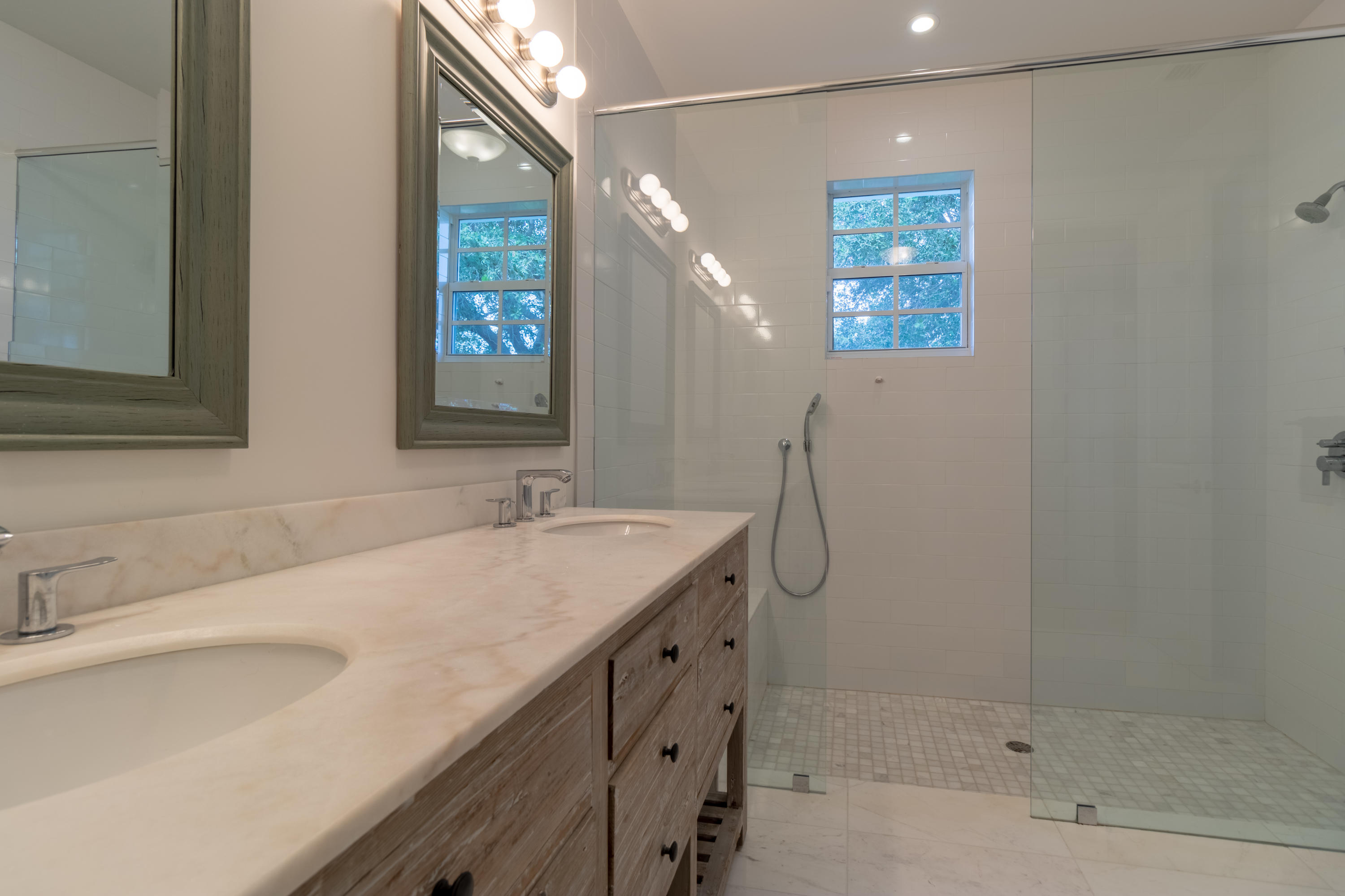 1085 Phillips Road Delray Beach, FL 33483 - Photo 14 of 32 a bathroom with a shower sink and mirror