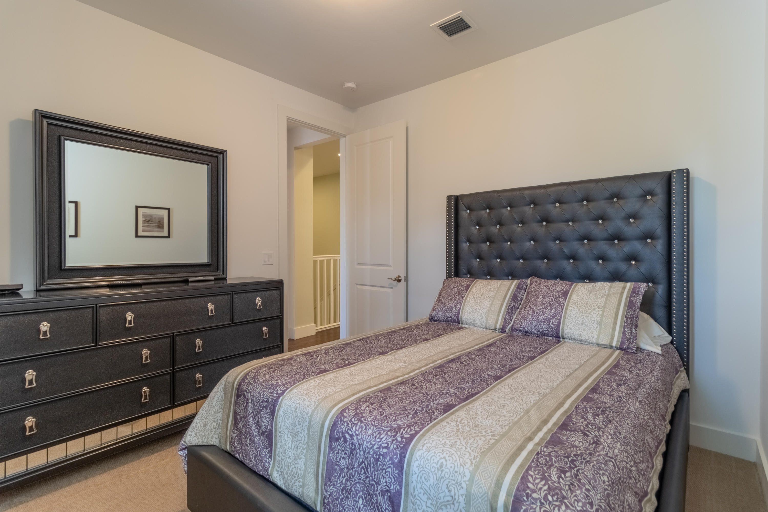 1085 Phillips Road Delray Beach, FL 33483 - Photo 17 of 32 a bedroom with a bed and a mirror