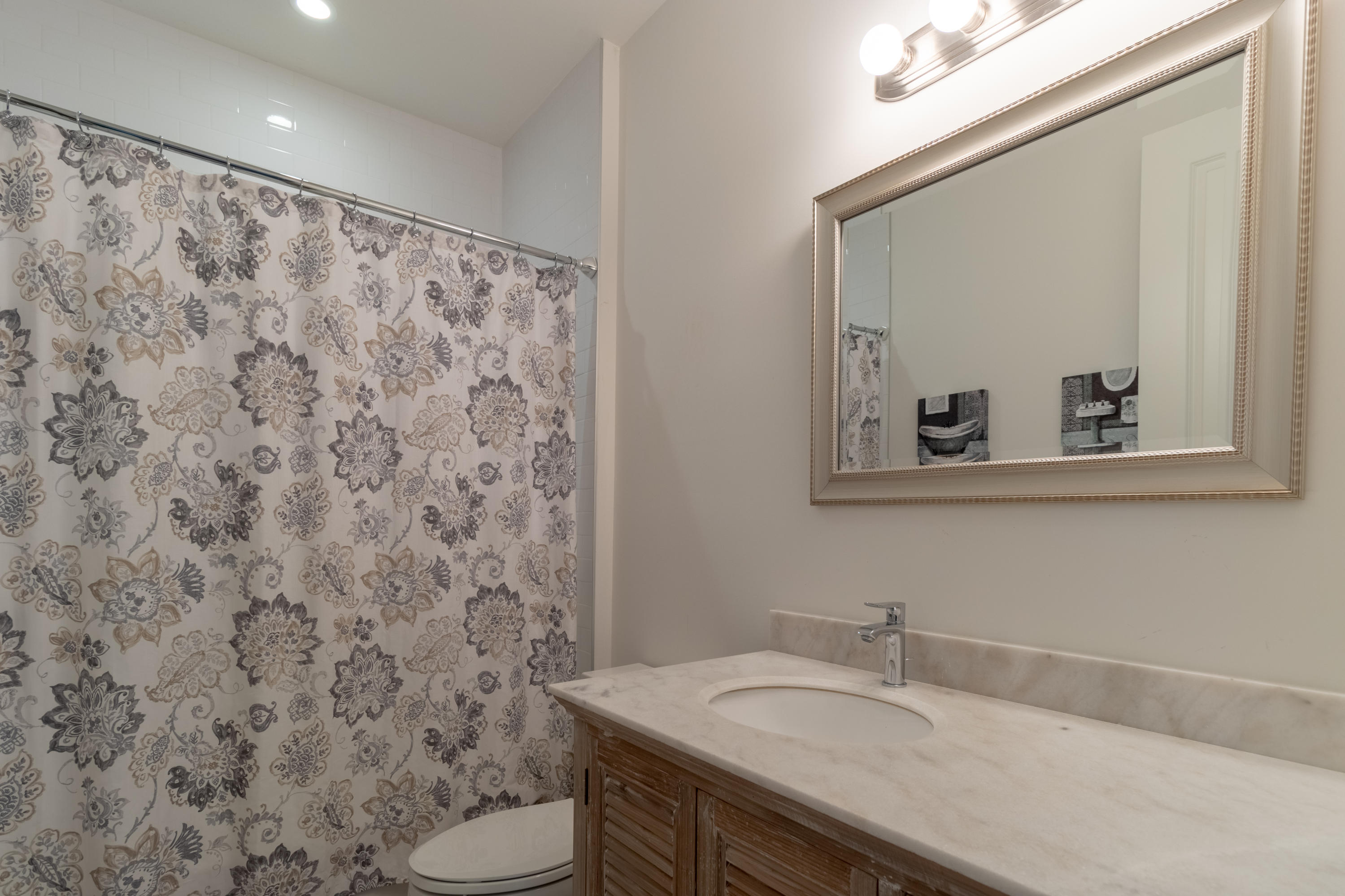 1085 Phillips Road Delray Beach, FL 33483 - Photo 21 of 32 a bathroom with a granite countertop sink and a mirror