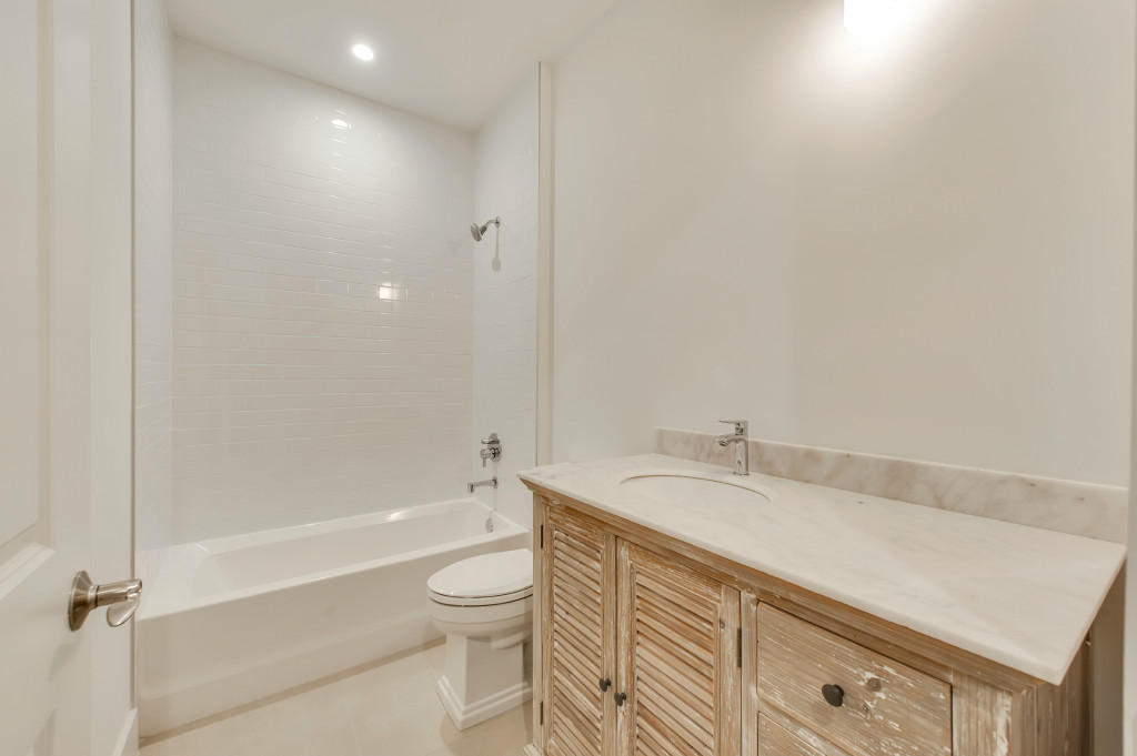 1085 Phillips Road Delray Beach, FL 33483 - Photo 22 of 32 a bathroom with a granite countertop sink a toilet and bathtub