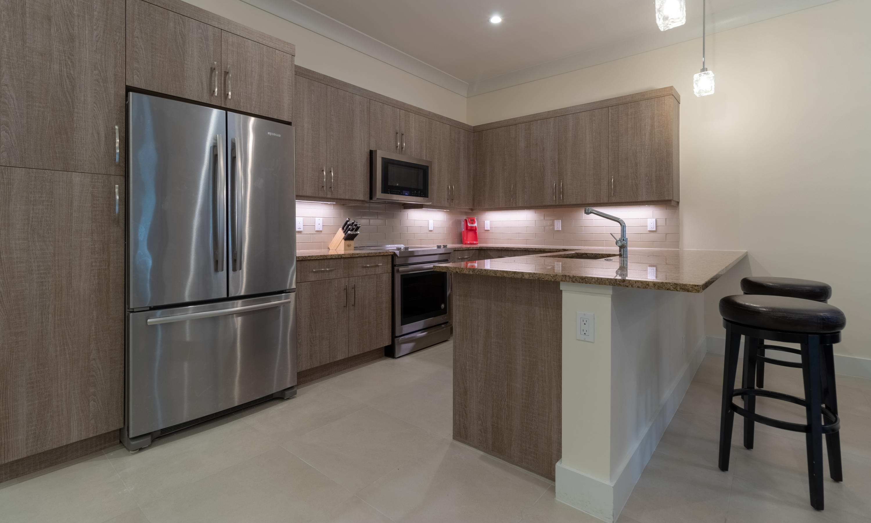 1085 Phillips Road Delray Beach, FL 33483 - Photo 7 of 32 a kitchen with stainless steel appliances a refrigerator stove microwave and sink