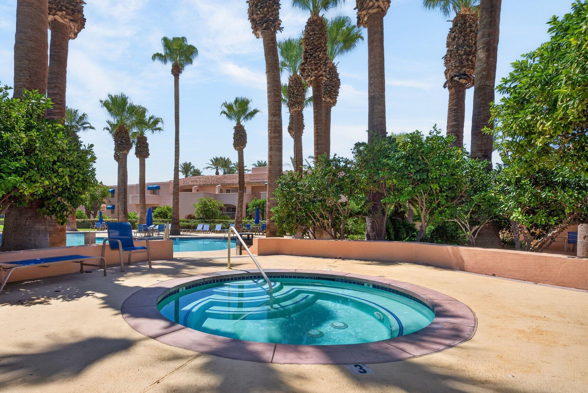 500 East Amado Road, Unit 313 Palm Springs, CA 92262 - Photo 26 of 32 a swimming pool with outdoor seating and plants
