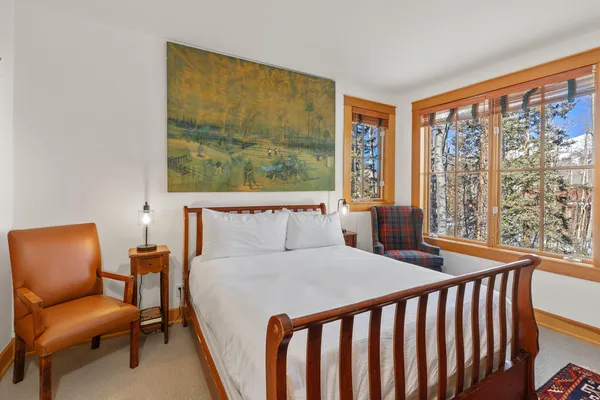 a bed sitting in a bedroom next to a window