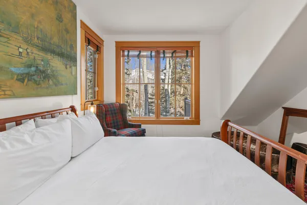 a bedroom with a bed and a window