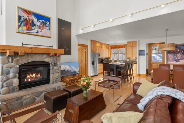 a living room with furniture fireplace and a large window