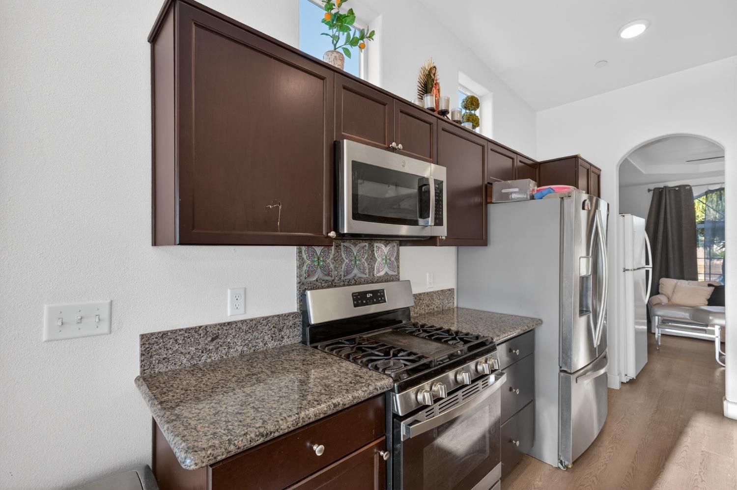 1208 Monterey Street Madera, CA 93637 - Photo 18 of 38 a kitchen with stainless steel appliances granite countertop a refrigerator and a stove top oven