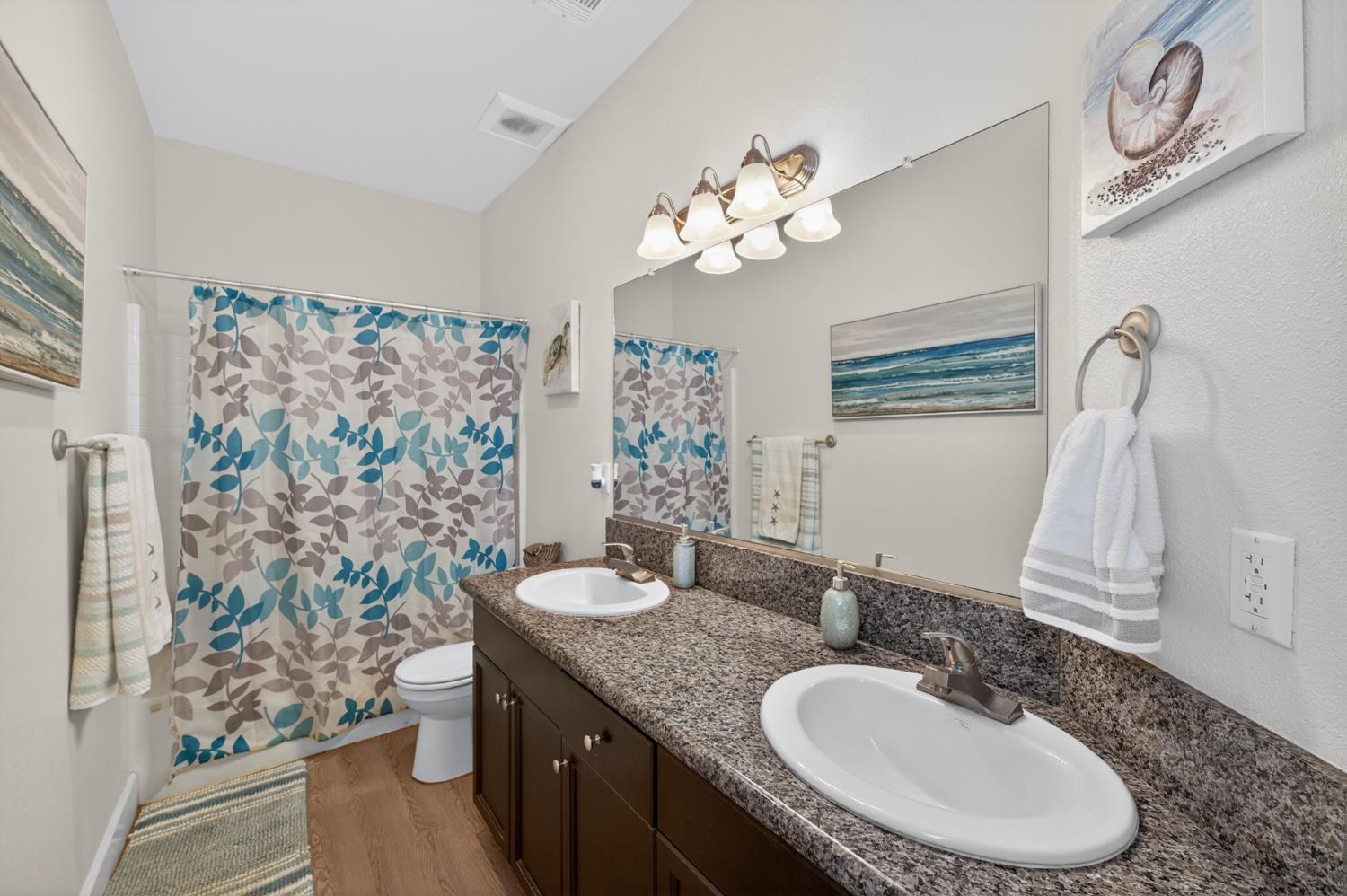 1208 Monterey Street Madera, CA 93637 - Photo 25 of 38 a bathroom with a granite countertop double vanity sink mirror and toilet