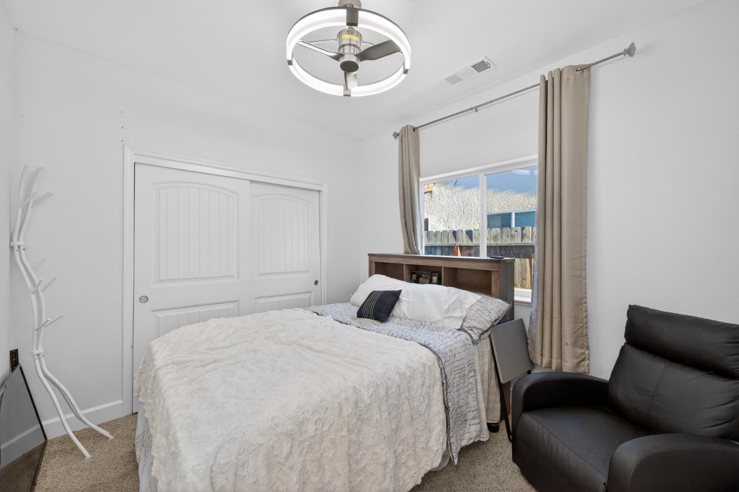 1208 Monterey Street Madera, CA 93637 - Photo 26 of 38 a bedroom with a bed and window