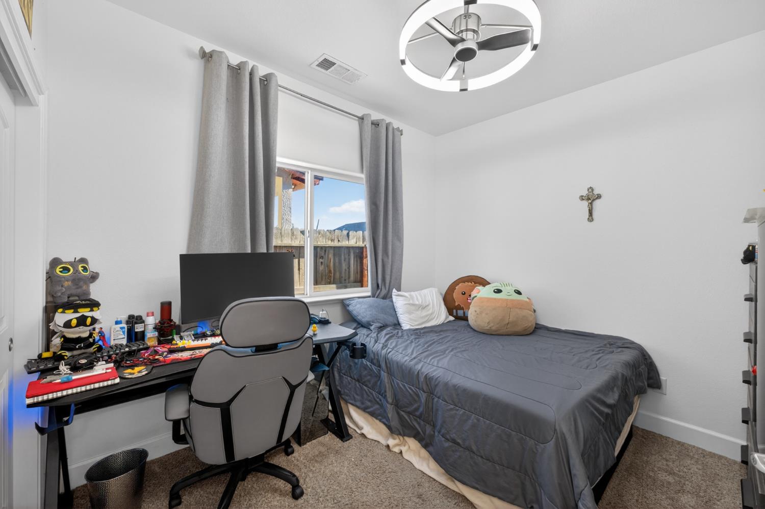 1208 Monterey Street Madera, CA 93637 - Photo 27 of 38 a bedroom with a bed and a chandelier