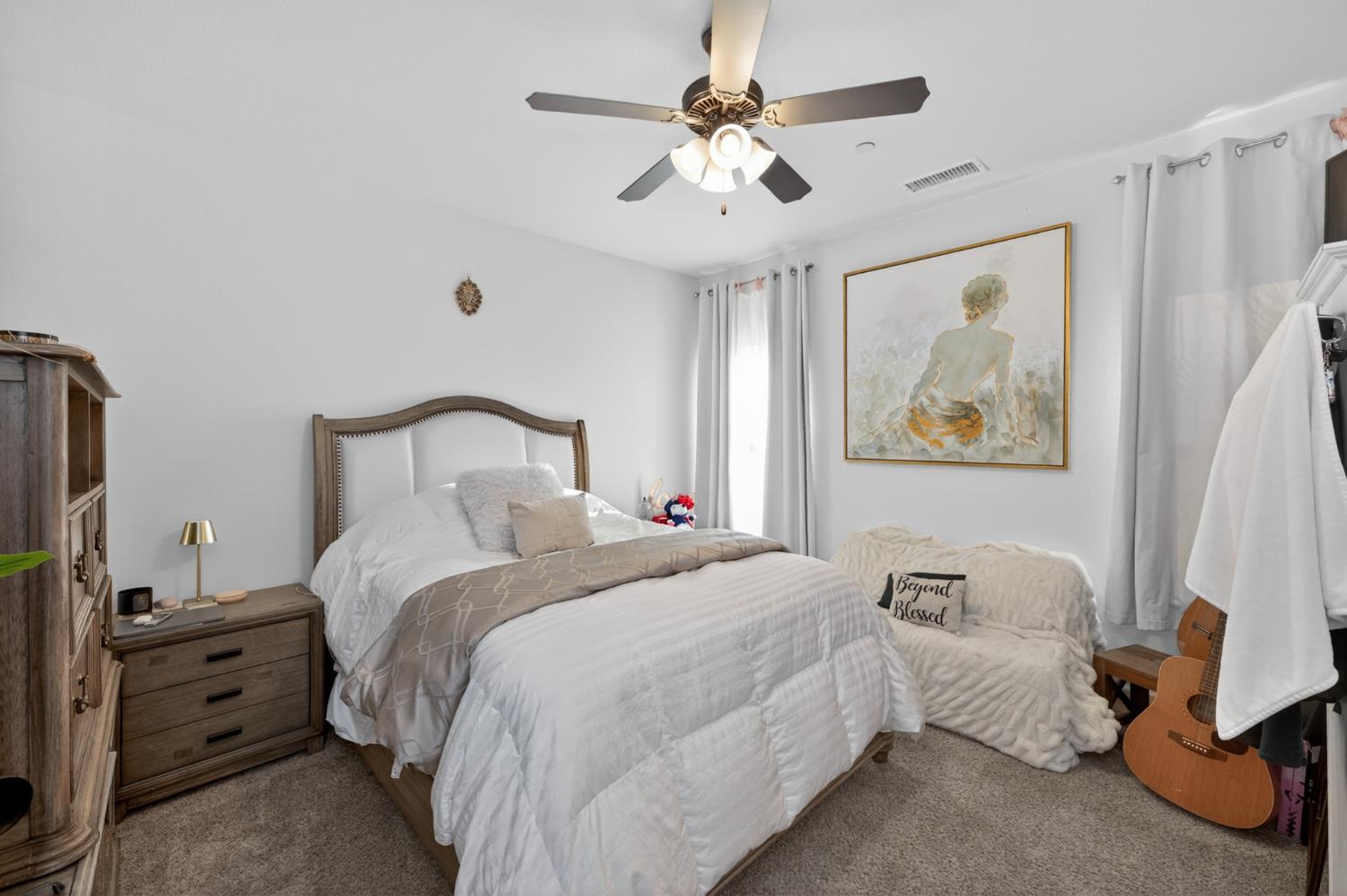 1208 Monterey Street Madera, CA 93637 - Photo 28 of 38 a bedroom with bed and a chandelier