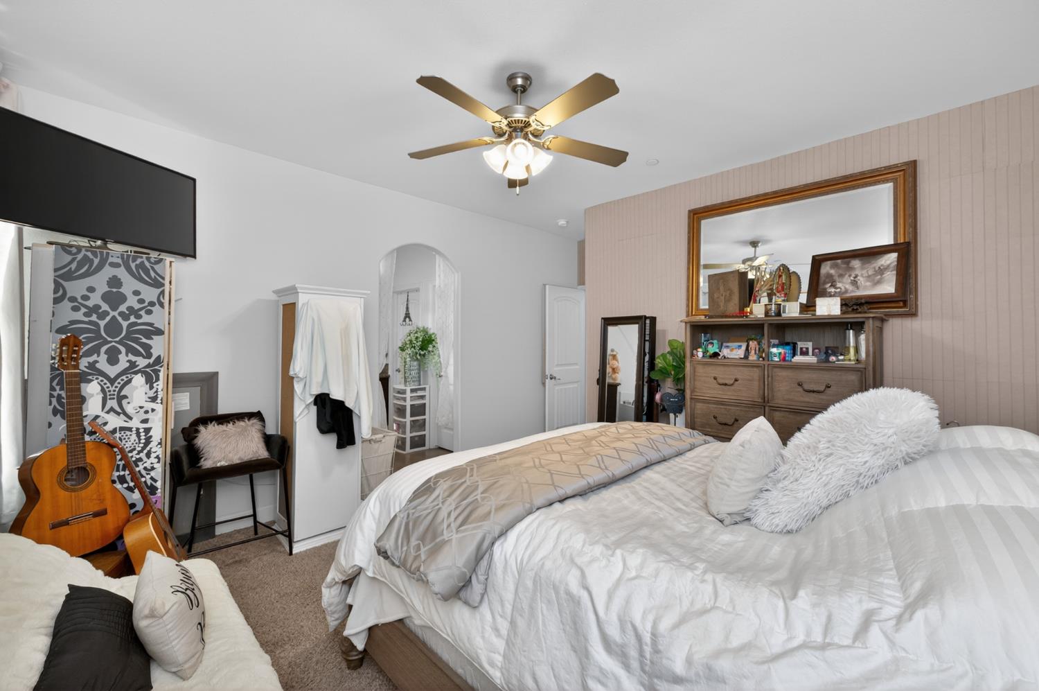 1208 Monterey Street Madera, CA 93637 - Photo 29 of 38 a bedroom with a bed and a chandelier