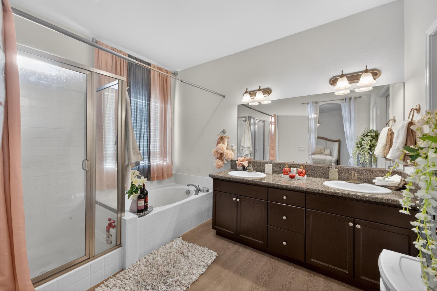1208 Monterey Street Madera, CA 93637 - Photo 30 of 38 a bathroom with a tub sink and mirror