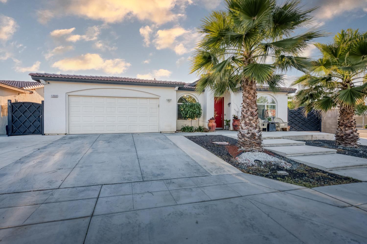 1208 Monterey Street Madera, CA 93637 - Photo 3 of 38 a view of a house with a yard and palm trees