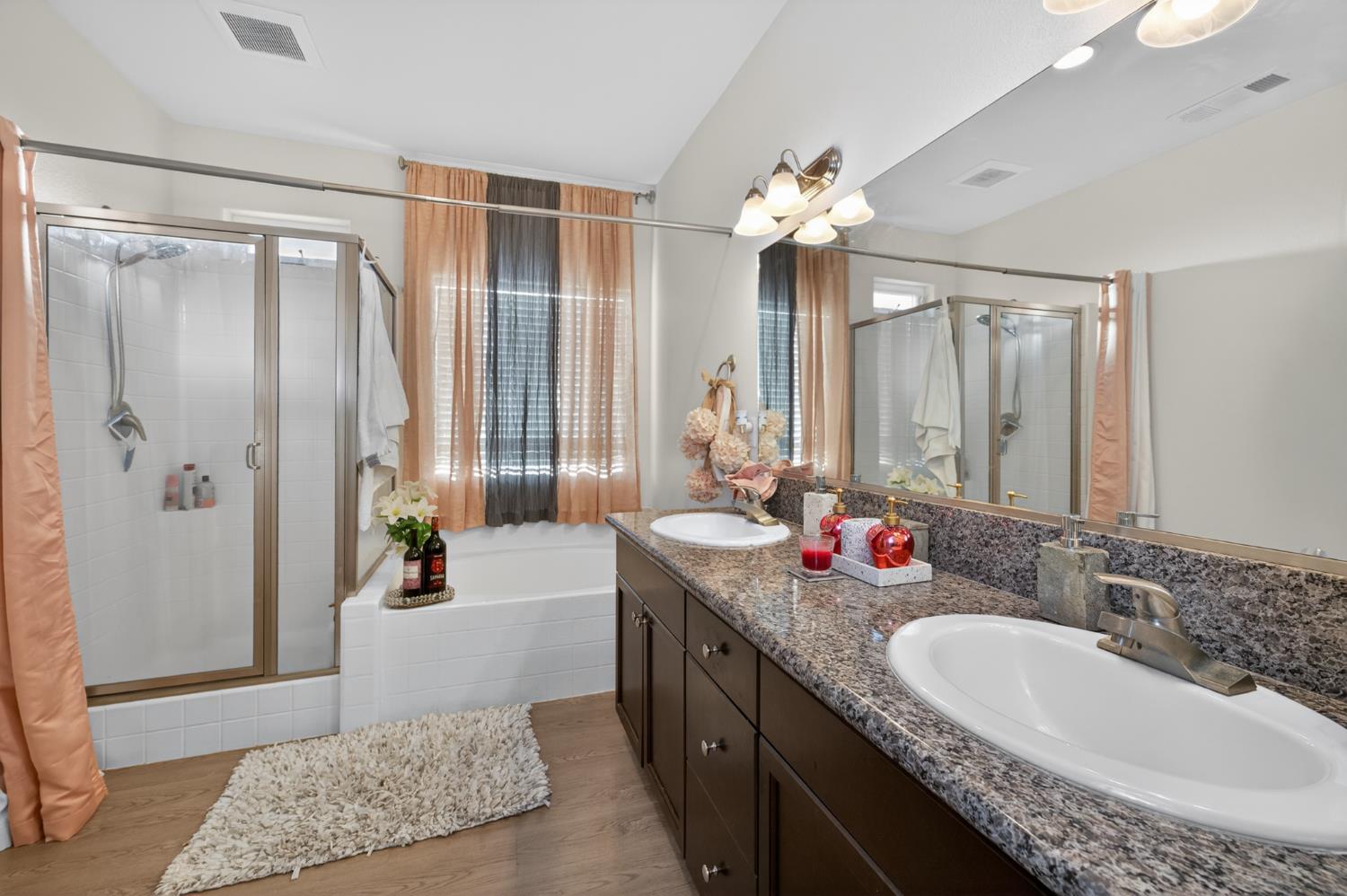 1208 Monterey Street Madera, CA 93637 - Photo 31 of 38 a spacious bathroom with a granite countertop sink a mirror and a bathtub