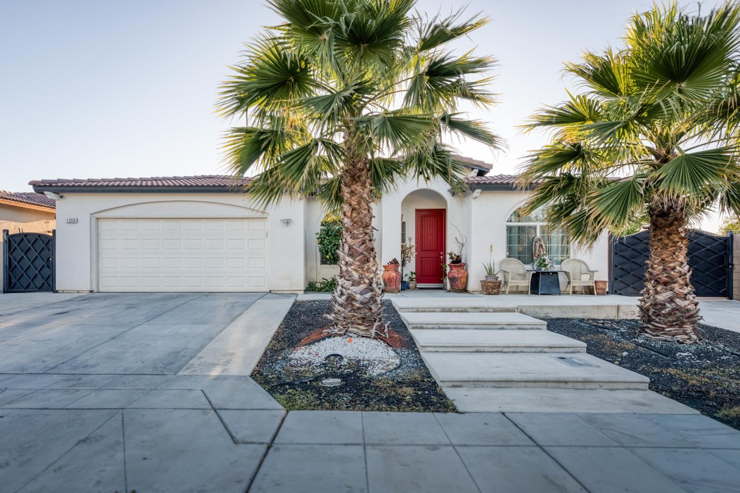 1208 Monterey Street Madera, CA 93637 - Photo 4 of 38 a view of a house with a yard and palm trees