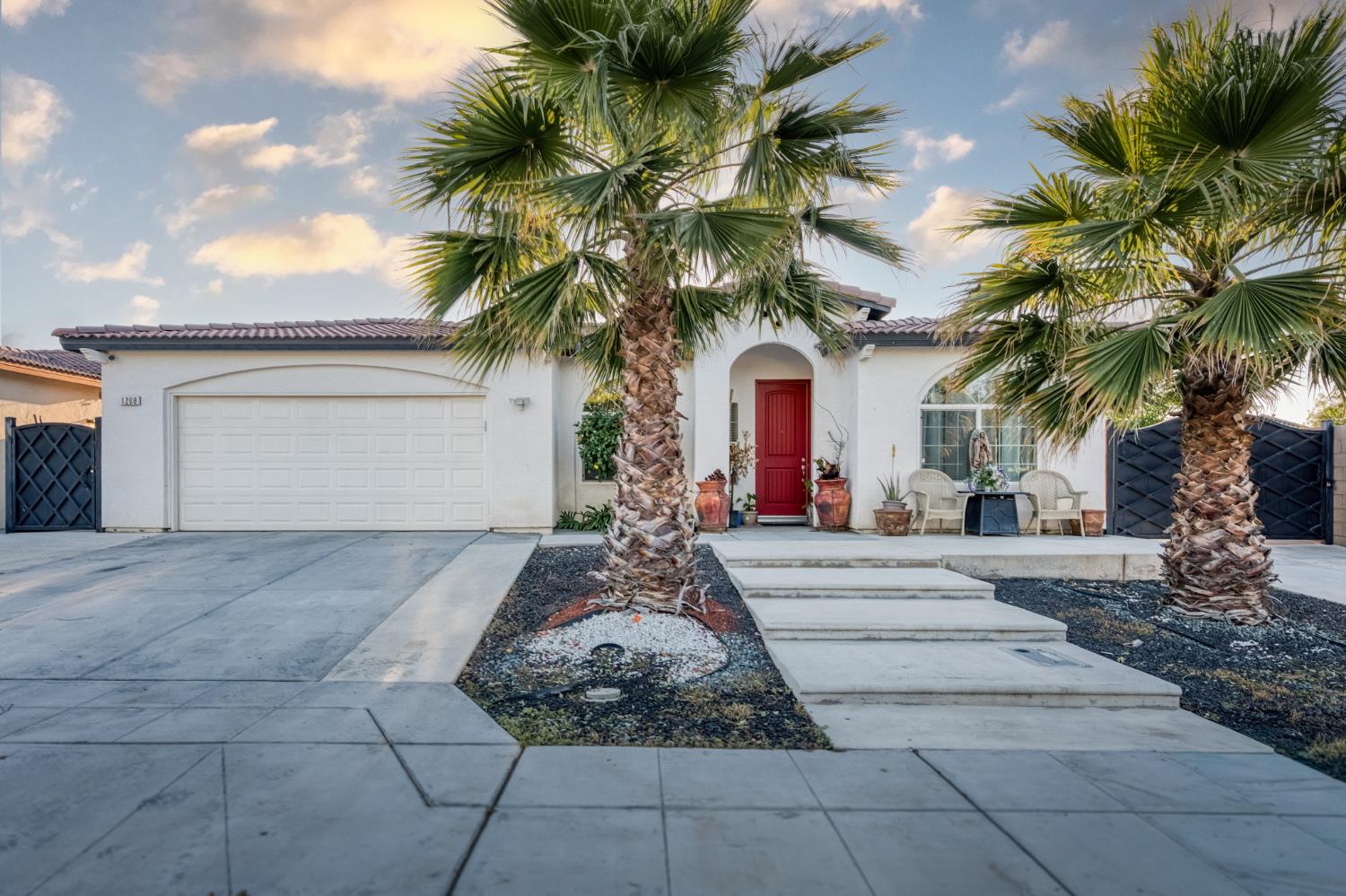 1208 Monterey Street Madera, CA 93637 - Photo 5 of 38 a view of a house with a yard and palm trees
