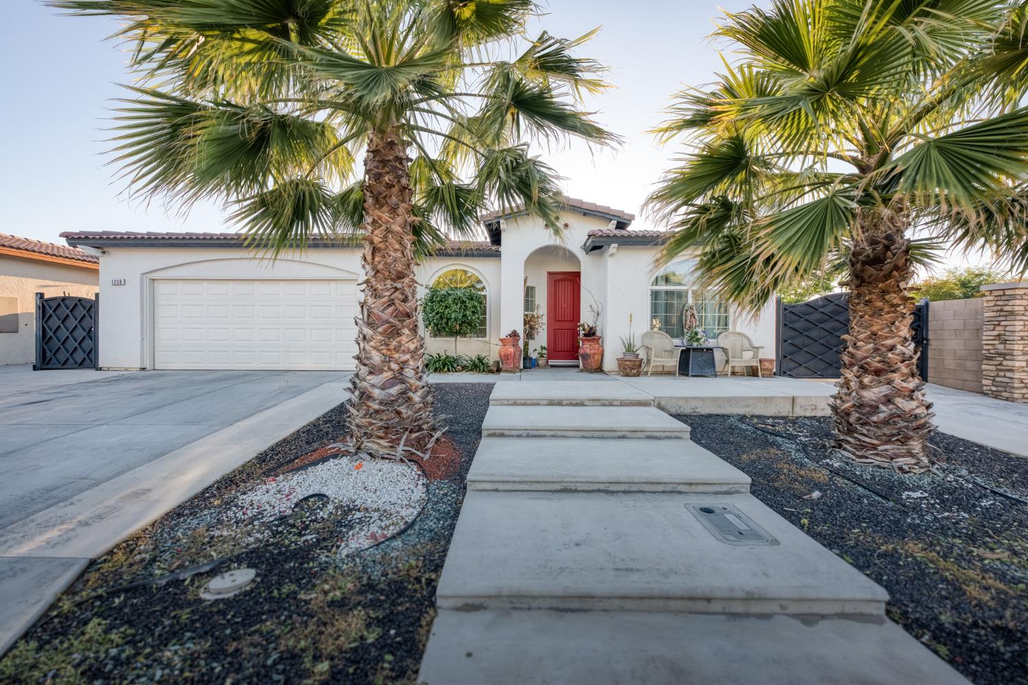 1208 Monterey Street Madera, CA 93637 - Photo 6 of 38 a front view of a house with a garden