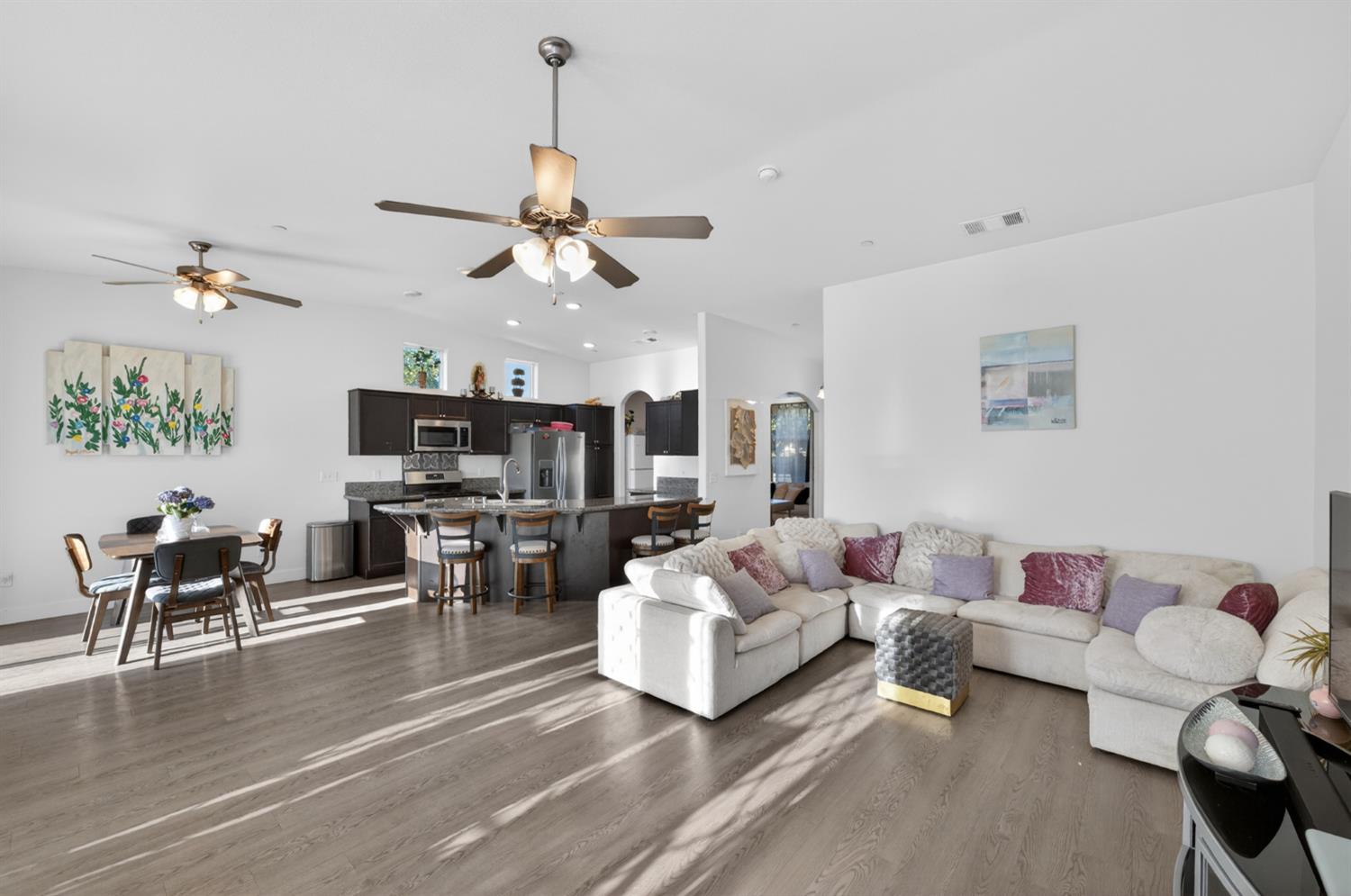 1208 Monterey Street Madera, CA 93637 - Photo 10 of 38 a living room with furniture kitchen view and a chandelier