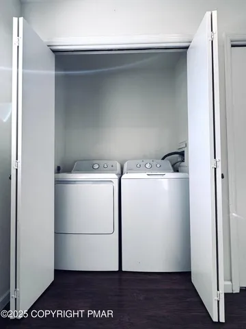 a bathroom with a granite countertop toilet sink and mirror