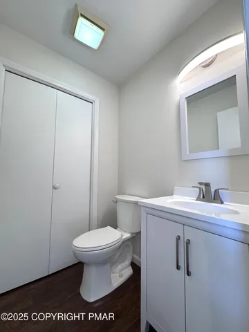 a bathroom with a sink toilet and mirror