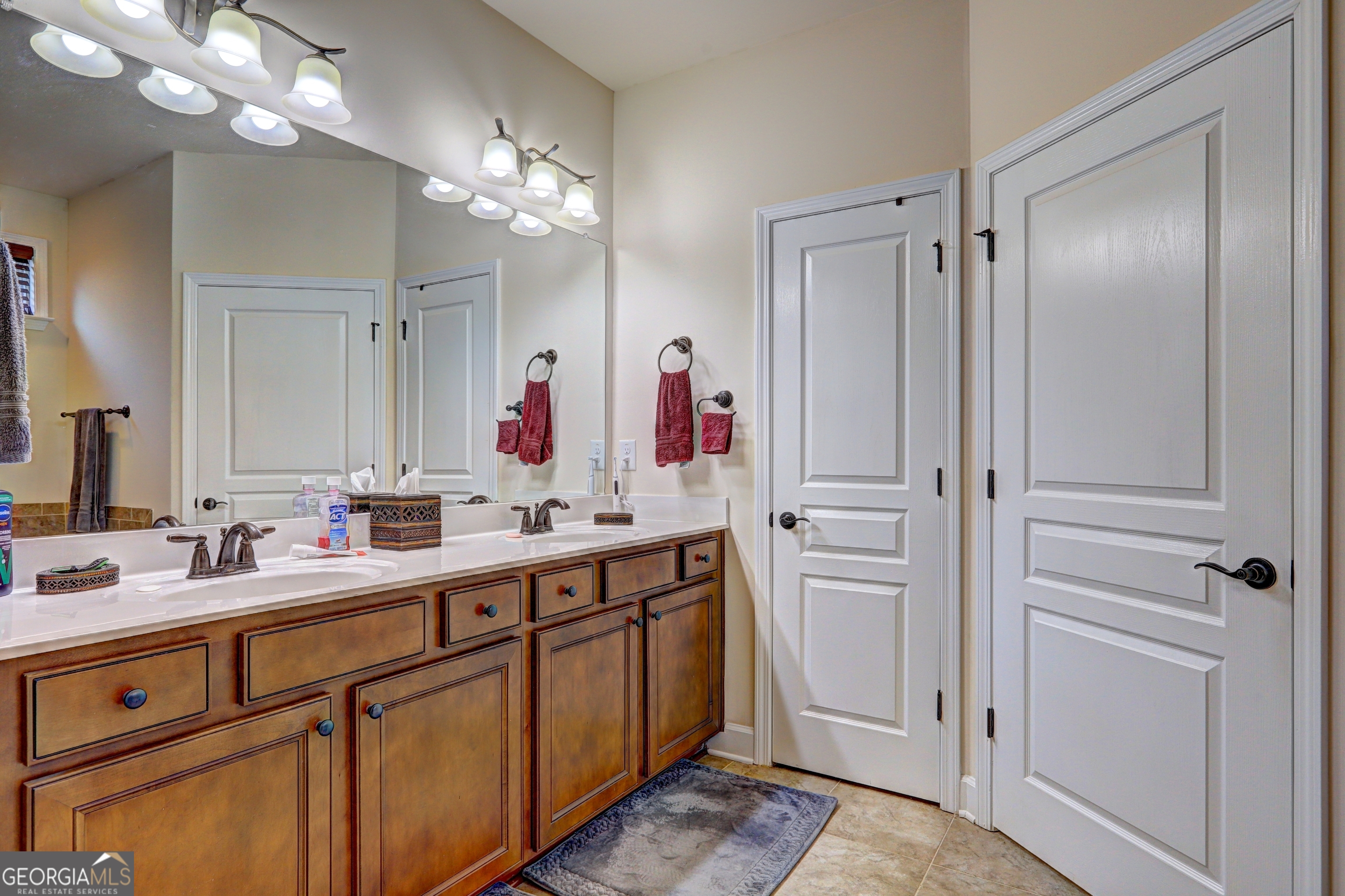 757 Firefly Court Griffin, GA 30223 - Photo 22 of 31 a bathroom with a double vanity sink mirror and double
