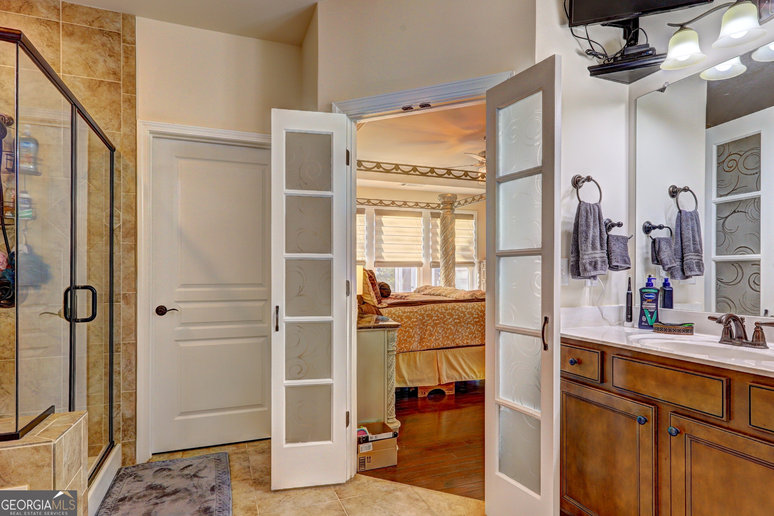 757 Firefly Court Griffin, GA 30223 - Photo 23 of 31 a bathroom with a double vanity sink a mirror and shower