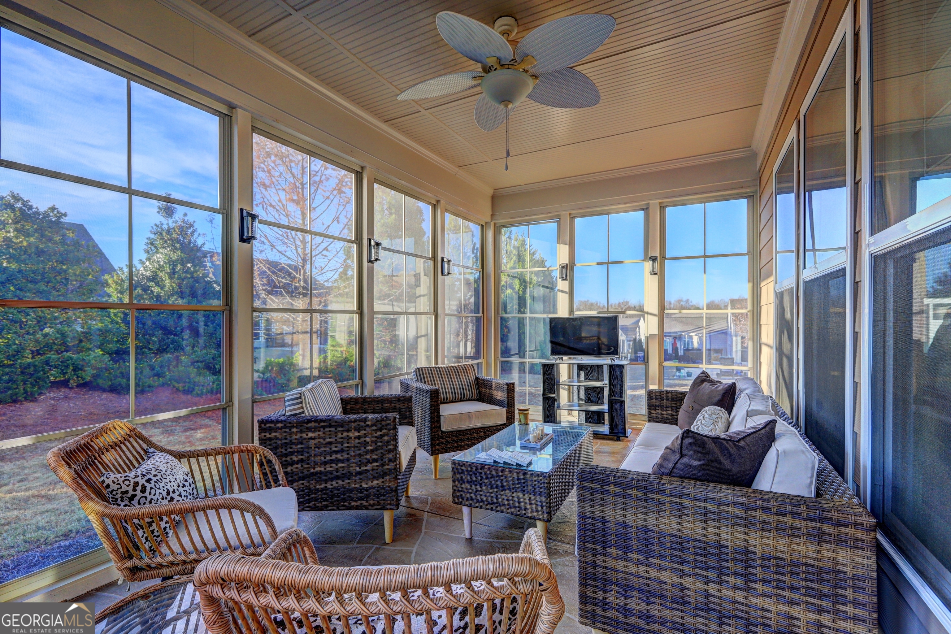757 Firefly Court Griffin, GA 30223 - Photo 9 of 31 a living room with furniture a ceiling fan and a floor to ceiling window