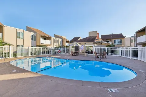 a swimming pool with outdoor seating and yard