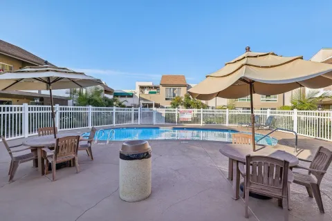 a view of a chairs and table in patio with a fire pit