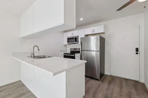 a kitchen with stainless steel appliances a refrigerator and a sink
