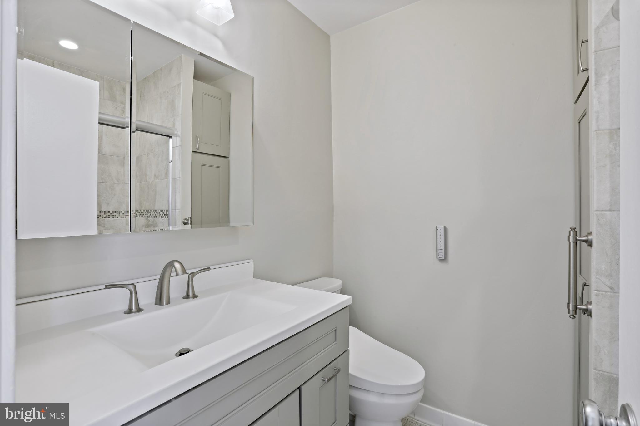 1644 Wainwright Drive Reston, VA 20190 - Photo 19 of 38 a bathroom with a sink a toilet and a mirror